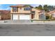 Two-story stucco home with a three-car garage and desert landscaping at 6586 W Mesa Vista Ave, Las Vegas, NV 89118