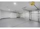 Spacious three-car garage with ample storage cabinets, insulated garage doors and epoxy flooring at 6586 W Mesa Vista Ave, Las Vegas, NV 89118