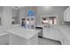 Modern kitchen with white cabinets, quartz countertops, and stainless steel appliances at 6586 W Mesa Vista Ave, Las Vegas, NV 89118