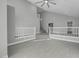Living room with vaulted ceilings, white railing, and neutral walls at 6586 W Mesa Vista Ave, Las Vegas, NV 89118