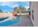 Private pool and covered patio in a backyard with artificial grass at 6586 W Mesa Vista Ave, Las Vegas, NV 89118