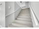 Clean stairway with light hardwood floors and white handrail at 6586 W Mesa Vista Ave, Las Vegas, NV 89118