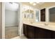 Double vanity bathroom with dark wood cabinets at 7620 Pleasant Colony Ct, Las Vegas, NV 89131