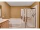 Bathroom with bathtub, shower, and light wood vanity at 9322 Boulder Opal Ave, Las Vegas, NV 89148