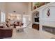 Living room with high ceilings, fireplace, and view of kitchen at 9322 Boulder Opal Ave, Las Vegas, NV 89148