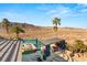 Elevated view of pool area with shaded seating, lush landscaping, and mountain views at 942 Villa Grande Way, Boulder City, NV 89005