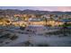 Sprawling estate aerial view at sunset with stunning pool, palm trees, and mountain backdrop at 942 Villa Grande Way, Boulder City, NV 89005