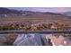 Bird's-eye view of a sprawling desert home featuring lush landscaping and mountain views at 942 Villa Grande Way, Boulder City, NV 89005