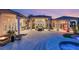 Expansive backyard with an outdoor kitchen, dining area, and a refreshing pool at 942 Villa Grande Way, Boulder City, NV 89005