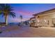Elegant outdoor living space featuring a spa, patio, and palm trees with views of the evening sky at 942 Villa Grande Way, Boulder City, NV 89005