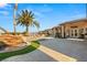 Expansive backyard featuring a waterfall, lush landscaping, and elegant paved patio at 942 Villa Grande Way, Boulder City, NV 89005