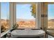 Luxury bathtub with stunning desert and mountain views through a large picture window at 942 Villa Grande Way, Boulder City, NV 89005
