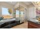 This bright bathroom offers scenic views, a large soaking tub, and a glass shower at 942 Villa Grande Way, Boulder City, NV 89005