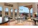 Bright dining area with a glass table set, mountain views, and an outdoor fire feature at 942 Villa Grande Way, Boulder City, NV 89005
