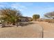 Long driveway leading to a home with mature trees and a three car garage at 942 Villa Grande Way, Boulder City, NV 89005