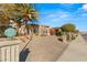 Stunning home exterior showcasing lush landscaping and a circular driveway at 942 Villa Grande Way, Boulder City, NV 89005