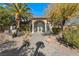 Beautiful home featuring mature landscaping and a grand entrance with tall glass doors at 942 Villa Grande Way, Boulder City, NV 89005