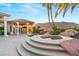 Outdoor hot tub with stone accents and scenic mountain views from the backyard patio at 942 Villa Grande Way, Boulder City, NV 89005