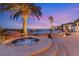 Relaxing hot tub with picturesque palm trees and infinity pool views, perfect for outdoor relaxation at 942 Villa Grande Way, Boulder City, NV 89005