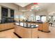 This kitchen offers sleek countertops, an island sink, and many windows for spectacular views at 942 Villa Grande Way, Boulder City, NV 89005