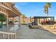 Luxury outdoor living area with covered seating, lush landscaping, and scenic mountain views at 942 Villa Grande Way, Boulder City, NV 89005