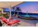 Inviting poolside lounge chairs with picturesque views of palm trees, fountain, and mountain scenery at 942 Villa Grande Way, Boulder City, NV 89005
