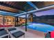 Inviting outdoor space with a pool, lounge chairs, and mountain views at dusk at 942 Villa Grande Way, Boulder City, NV 89005