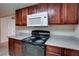 Kitchen with dark wood cabinets, granite counters and appliances at 5060 Indian River Dr # 377, Las Vegas, NV 89103