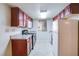 Galley kitchen with dark wood cabinets and appliances at 5060 Indian River Dr # 377, Las Vegas, NV 89103