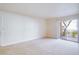 Spacious living room with neutral carpeting and access to a balcony at 5060 Indian River Dr # 377, Las Vegas, NV 89103