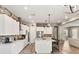 Open concept kitchen boasting white cabinets, a center island, and hardwood floors at 10086 Mountain Foothills Ave, Las Vegas, NV 89149