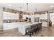 Modern kitchen featuring white cabinets, a large island, and a brick backsplash at 10086 Mountain Foothills Ave, Las Vegas, NV 89149