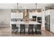 Modern kitchen with white cabinets, a large island, and brick backsplash at 10086 Mountain Foothills Ave, Las Vegas, NV 89149