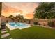 Relaxing pool and spa area with artificial turf and a built-in grill at 10086 Mountain Foothills Ave, Las Vegas, NV 89149