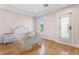 Charming bedroom with light pink walls, hardwood floors, and a decorative white bed frame at 10117 Summit Canyon Dr, Las Vegas, NV 89144