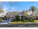 Beautiful two-story home featuring a stone facade, manicured lawn, and a three-car garage, set against a clear blue sky at 10117 Summit Canyon Dr, Las Vegas, NV 89144