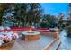 Backyard featuring an inviting stone fire pit with built in seating and decorative flower pots at 10117 Summit Canyon Dr, Las Vegas, NV 89144