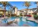 Inviting outdoor patio with comfortable lounge chairs, lush greenery, and an elegant architectural design at 10117 Summit Canyon Dr, Las Vegas, NV 89144