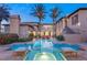 Resort-style backyard with a sparkling pool, spa, and lush landscaping at 10117 Summit Canyon Dr, Las Vegas, NV 89144