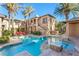 Beautiful backyard featuring a refreshing pool, spa, lush palm trees, and comfortable lounge chairs for relaxation at 10117 Summit Canyon Dr, Las Vegas, NV 89144