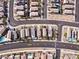 This aerial view shows a neighborhood with neatly arranged homes, desert landscaping, and community streets at 1012 Water Cove St, Henderson, NV 89011