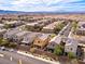 High angle view of community showing homes with solar panels, desert landscaping, and mountain backdrop at 1012 Water Cove St, Henderson, NV 89011