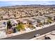 Lovely aerial view of a community with a two-story home, desert landscaping and mountain views at 1012 Water Cove St, Henderson, NV 89011