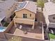 Aerial of backyard including gravel landscaping, fire pit, small grass, and solar panels above at 1012 Water Cove St, Henderson, NV 89011