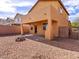 Spacious backyard featuring a gravel area, brick perimeter, and outdoor fire pit at 1012 Water Cove St, Henderson, NV 89011