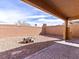 Spacious backyard featuring a gravel area, brick perimeter, and outdoor fire pit at 1012 Water Cove St, Henderson, NV 89011