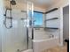 Bathroom boasting a glass-enclosed shower, soaking tub, and a view-providing window, creating a spa-like feel at 1012 Water Cove St, Henderson, NV 89011