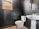 Bathroom featuring a pedestal sink, toilet, black walls, and tile floors at 1012 Water Cove St, Henderson, NV 89011