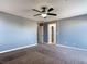Large bedroom showcasing neutral walls, carpeting, and a ceiling fan, with doorways leading to other rooms at 1012 Water Cove St, Henderson, NV 89011