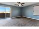 Empty bedroom featuring a ceiling fan, balcony access, and large window offering clear views and natural light at 1012 Water Cove St, Henderson, NV 89011
